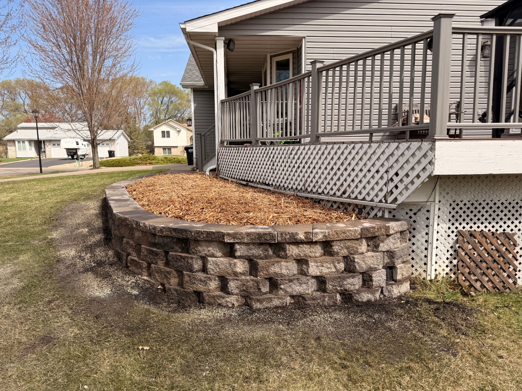 Ramsey, MN retaining wall rebuild with curved stone block planter